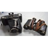 A leather-cased pair of binoculars by Sherwood & Co,