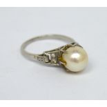 A ladies' white metal dress ring set with a single pearl in core setting and Art Deco style