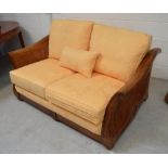 A large hardwood Multiyork bergère-style sofa with yellow damask loose cover, length 150cm.