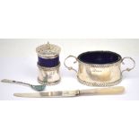 A George V hallmarked silver twin-handled salt cellar with rope twist decoration and blue liner,