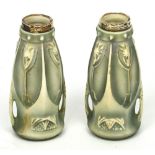 A pair of Art Nouveau style green ground vases with streamline twin handles,