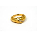 An 18ct yellow gold ring set with seven diamonds in an 'X' shaped design, size M, approx 5.1g.