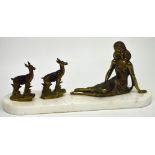 An Art Deco style bronze-effect figural group of a young girl with two deer on a marbled plinth,