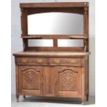 An Edwardian walnut mirror-back sideboard, back with three panel bevelled mirrors,