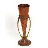 A WMF Art Deco copper and brass twin-handled trumpet vase with raised floral decoration,