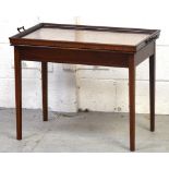 An Edwardian mahogany inlaid butler's table tray with glass base and brass handles, length 73cm.