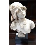 A marble-effect bust of a young woman in peasant costume, on a marble-effect base, height 29cm.