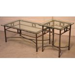 A contemporary rectangular glass-top coffee table with ornate metal base,