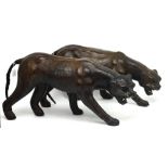 Two large decorative leather models of stalking panthers, length of each 65cm (2).