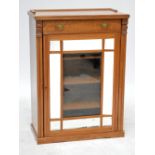 A late Victorian music/display cabinet with single drawer above mirrored and glazed door enclosing