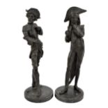 A pair of spelter candlesticks modelled as caricatural gentlemen, on circular bases, height 32cm.