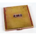 An Art Deco style gold plated square section engine turned decorated mirrored powder compact with