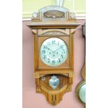 A 1930s Art Deco walnut wall clock, with shaped case,