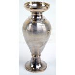 A sterling silver baluster vase with linear engine turned decoration and vacant cartouche,
