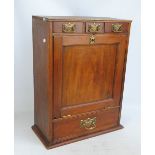 A pine table cabinet with three short drawers above a hinged fall-front and a single full length