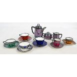 A small collection of variously coloured and silver overlaid porcelain cabinet cups and saucers to