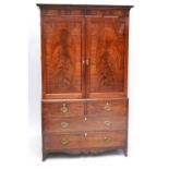 A 19th century mahogany linen press with pair of inlaid doors above two short and two long drawers,