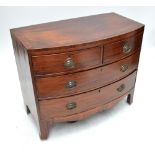 An early 19th century mahogany bowfronted chest of two short and two long drawers.