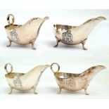 JAMES DIXON & SONS; a set of four George V hallmarked silver sauce boats with circular handles,