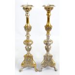 A pair of brass and silver plated pricket candlesticks with knopped and foliate cast stems above