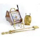 A pair of brass andirons, a three piece companion set, a brass mounted coal scuttle with shovel,