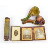 A cased Meerschaum pipe decorated as a black man's head with amber coloured mouthpiece and silver