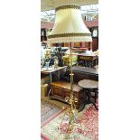 A late 19th/early 20th century telescopic brass standard lamp with scroll decoration.