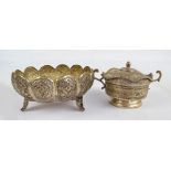 An Iranian base white metal shaped circular panelled bowl with engraved and embossed floral and