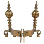 A pair of late 19th century gun metal andirons with lobed bulbous finials above scrolling front