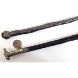 A good and unusual lady's carriage whip, with white metal dog's head finial,