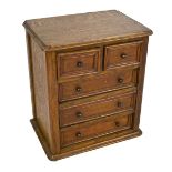 An oak miniature chest with rounded corners with two short above three long drawers, width 29cm.