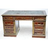 A French Empire Revival mahogany and brass set twin pedestal desk,
