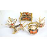 Five Royal Crown Derby miniature pieces including a kettle, watering can and a bench (5).