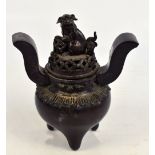 A 19th century Chinese bronze koro and cover surmounted with a figure of a seated Dog of Fo,