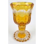 A circa 1900 Bohemian clear and amber tinted glass goblet of faceted bell shaped form,