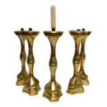 A set of five 20th century large brass candlesticks with ring turned central columns to tripartite