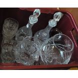 A group of clear cut glass items to include a pair of slender bottle shaped decanters and a large