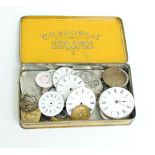 A group of pocket and wristwatch enamel dials, some with movements.