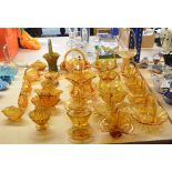 A collection of 19th and 20th century amber tinted glass baskets including two navette form