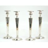 A set of four 20th century silver candlesticks, of rectangular tapering form,