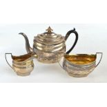 SOLOMON HOUGHAM; a George III hallmarked silver three piece tea set comprising an oval teapot,