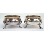 A pair of George II hallmarked silver circular open salts with cast rims and gilt wash interiors,