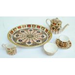 A Royal Crown Derby Imari pattern five piece miniature tea set comprising teapot, cup and saucer,