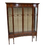 A large Edwardian mahogany and inlaid display cabinet with inverted breakfront,