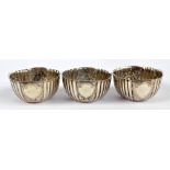 A set of three Victorian hallmarked silver small circular salts with foliate and ribbed panels of