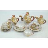 A 20th century Japanese porcelain tea set profusely decorated in gilt and enamels with dragon motif