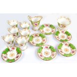 A Coalport porcelain six setting floral decorated coffee set comprising tapering coffee cans with