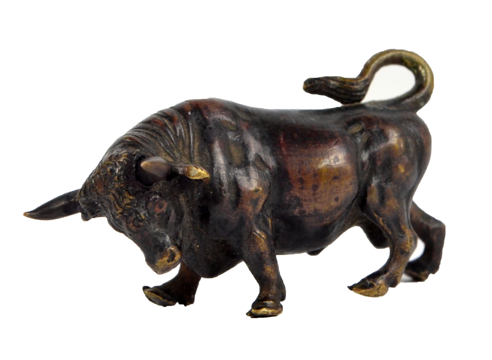 An early 20th century bronze figure of a bull, length 5cm.