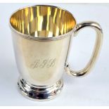 JOHN ROSE; an Elizabeth II hallmarked silver bell shaped christening mug with loop handle,