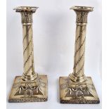 A pair of George III hallmarked silver loaded candlesticks with detachable sconces,